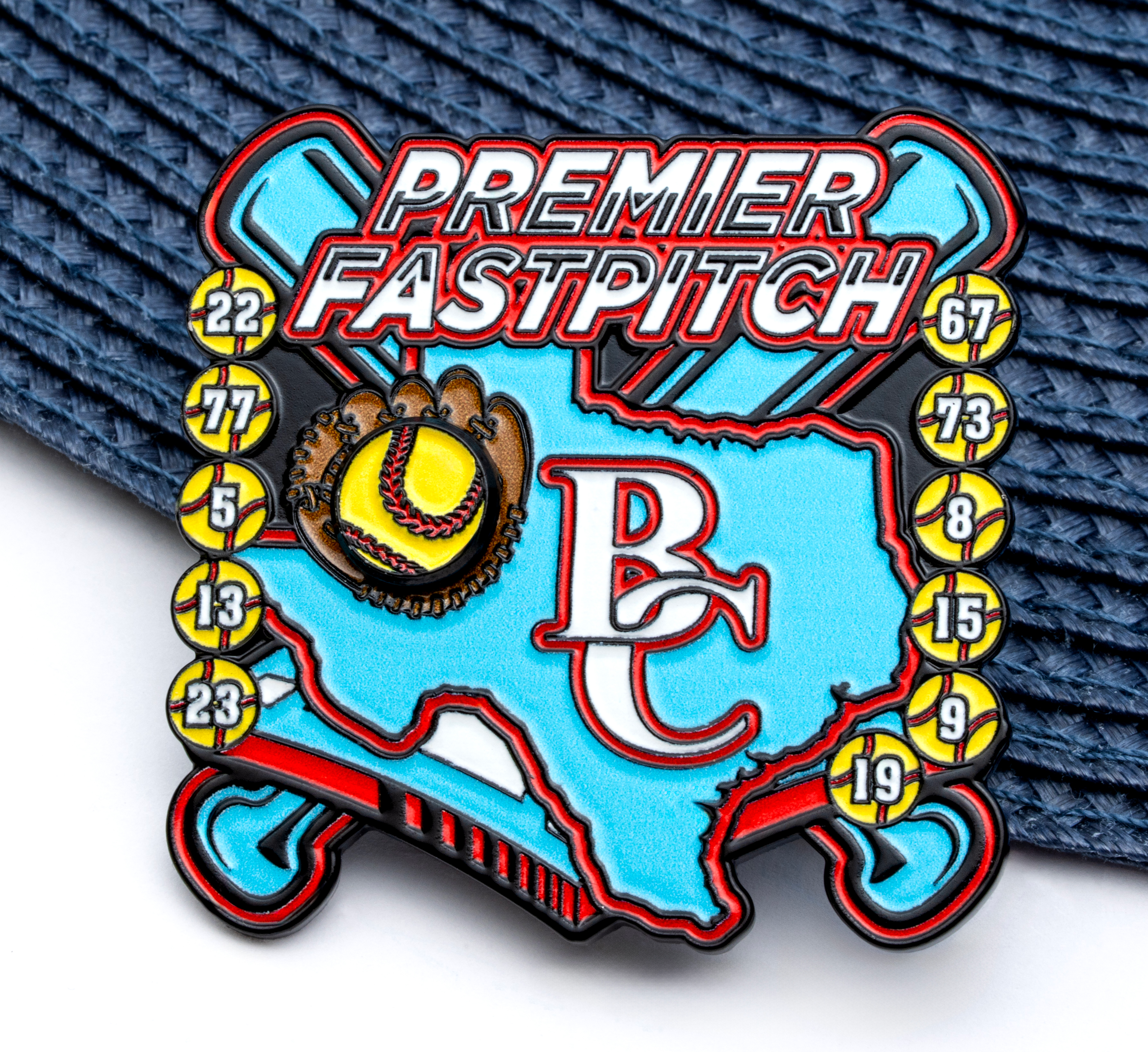 Soft enamel softball trading pin featuring the state of Texas, crossed bats, a glove with a ball, and the text Premier Fastpitch BC.