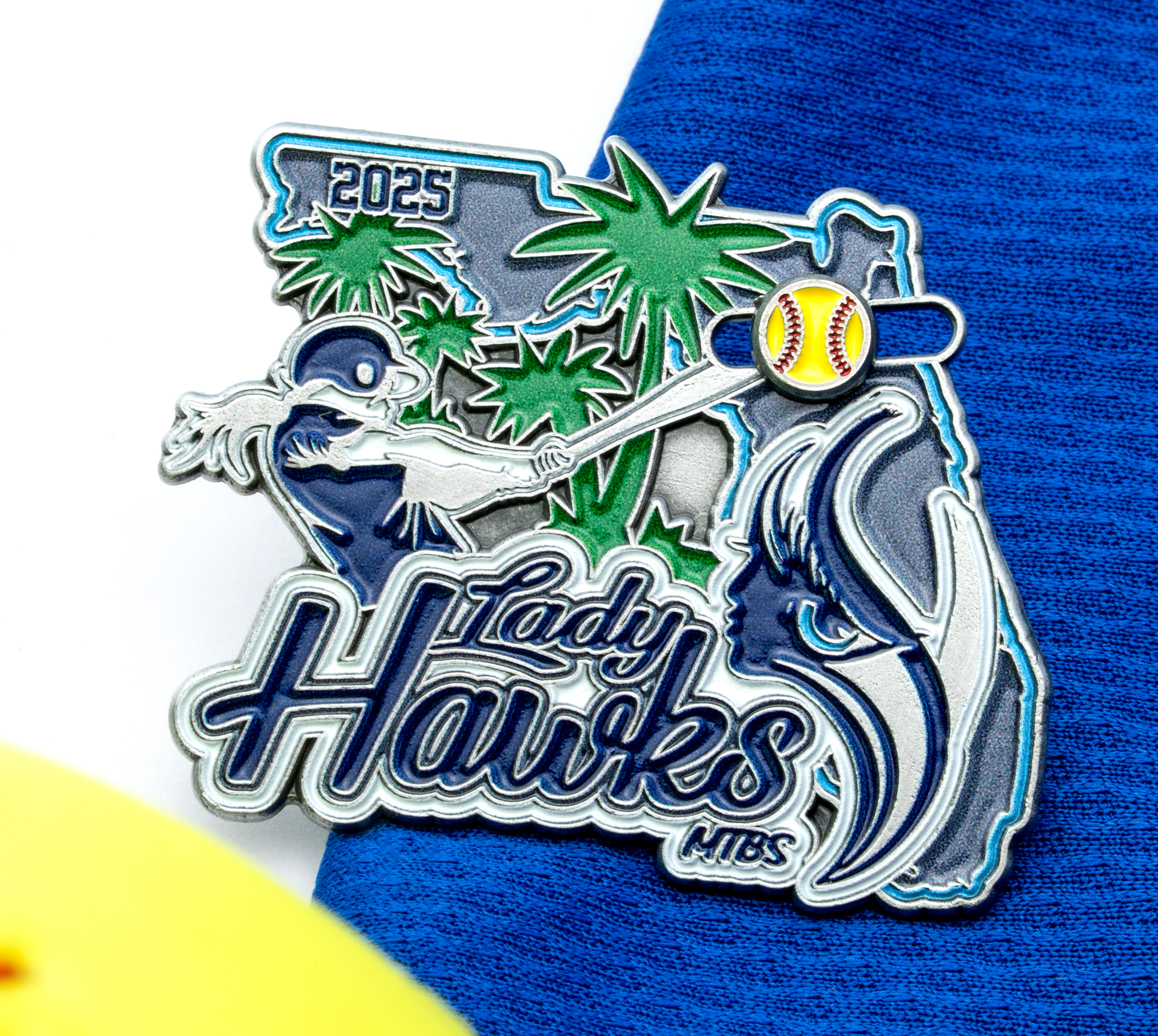 A custom enamel lapel pin for Lady Hawks MIBS featuring a softball player, palm trees, and the state of Florida outline.