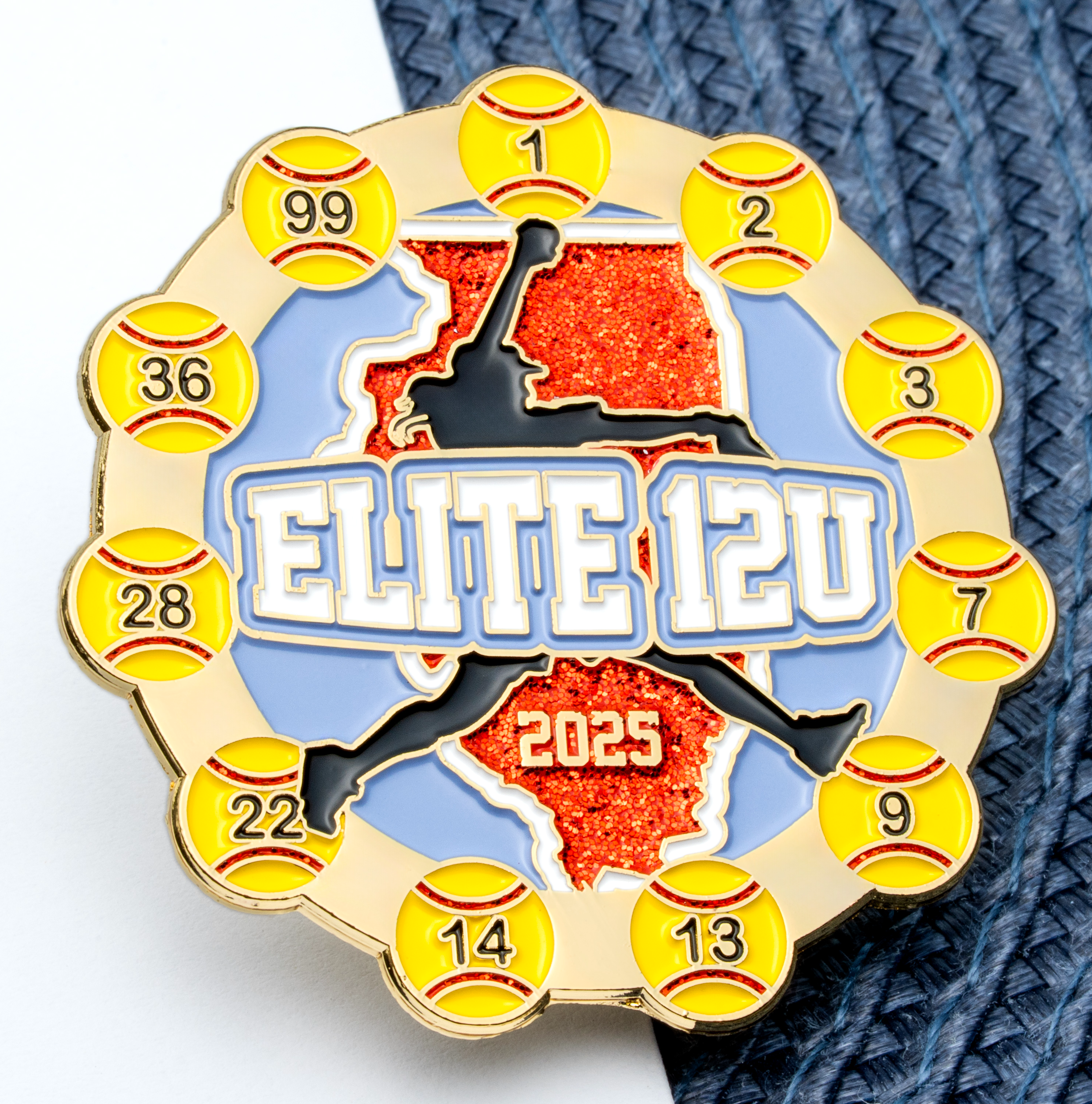 Circular softball trading pin featuring a player silhouette over an orange glitter Illinois map, surrounded by yellow softballs with jersey numbers.