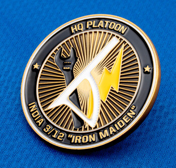 Circular challenge coin with gold and black enamel featuring a wrench, saw, and lightning bolt, inscribed with HQ Platoon India 3/12 Iron Maiden.