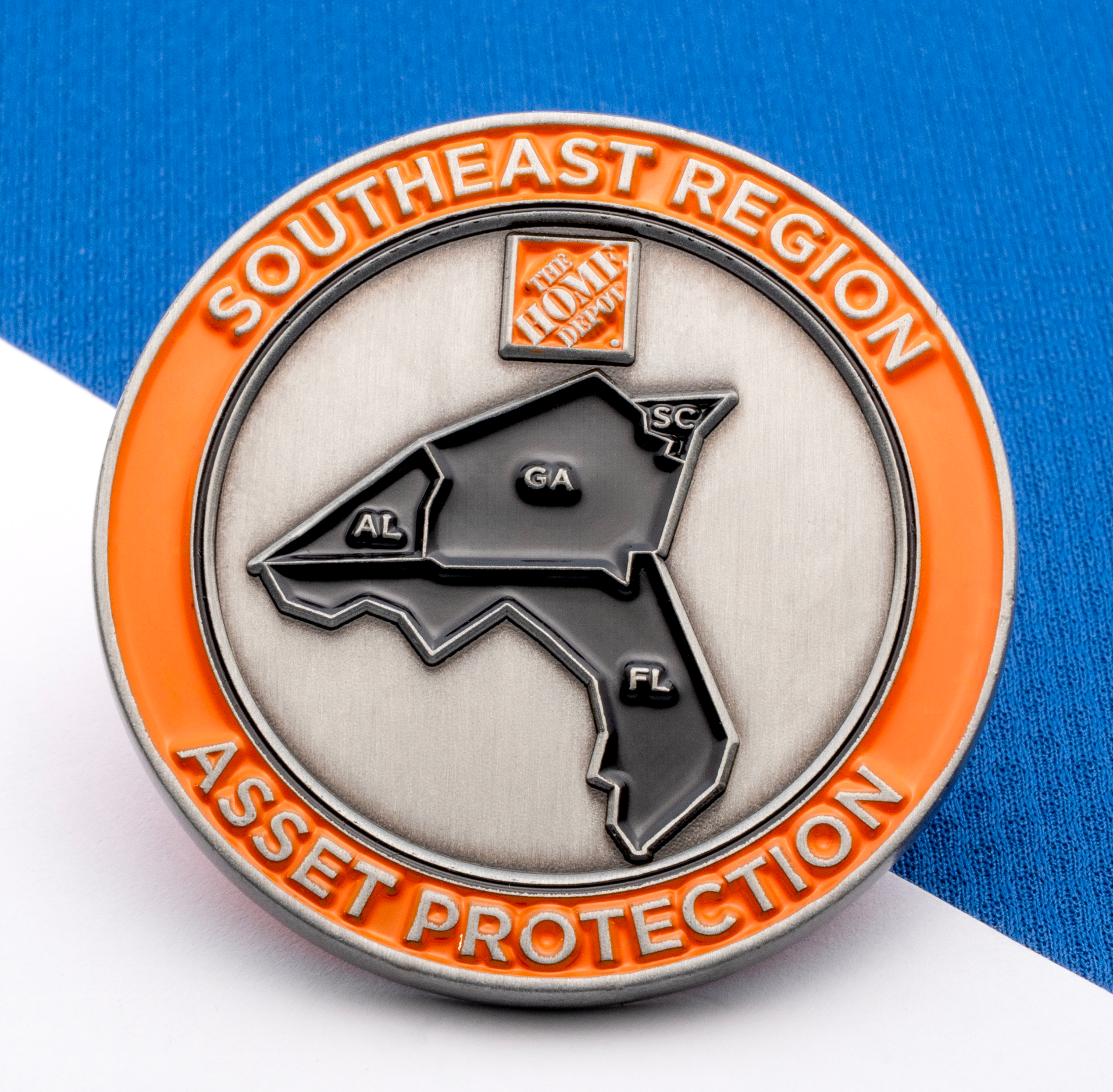 Circular challenge coin for Southeast Region Asset Protection featuring a map of AL, GA, SC, and FL with The Home Depot logo.