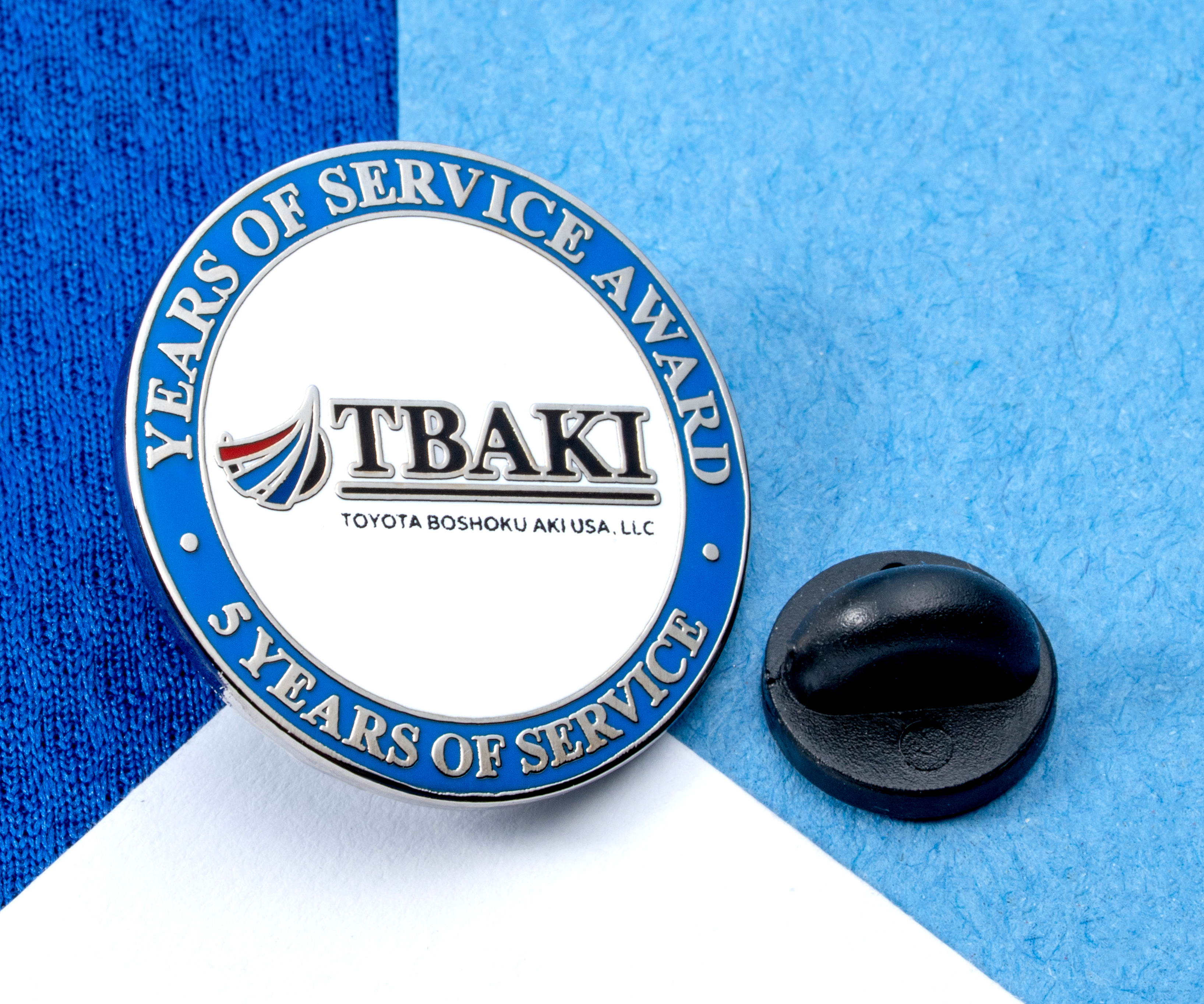 map[name:Circular lapel pin for TBAKI 5 Years of Service Award with blue and white enamel and a black rubber clutch. naturalSort:Circular lapel pin for TBAKI 00000000000000000000000000000005.00000000000000000000000000000000  Years of Service Award with blue and white enamel and a black rubber clutch.]