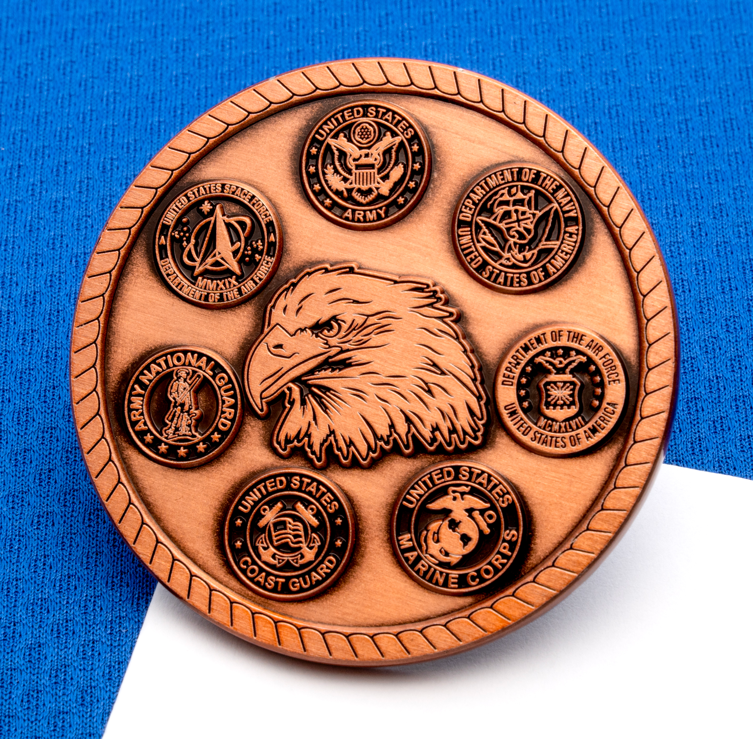 map[name:Antique copper challenge coin featuring an eagle head surrounded by seals for the Army, Navy, Air Force, Marine Corps, Coast Guard, Space Force, and National Gu naturalSort:Antique copper challenge coin featuring an eagle head surrounded by seals for the Army, Navy, Air Force, Marine Corps, Coast Guard, Space Force, and National Gu]