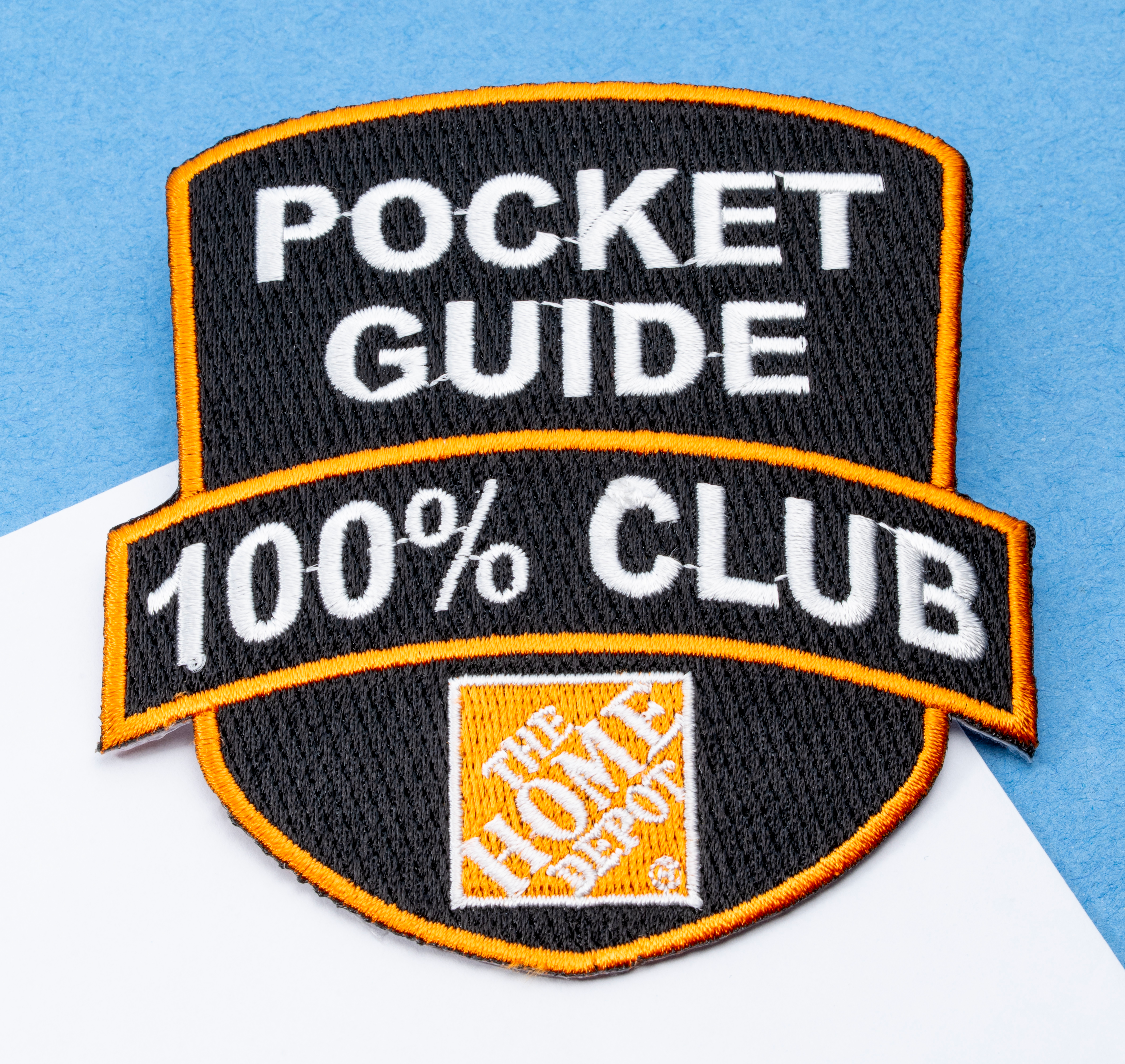 map[name:Embroidered shield-shaped patch with black background, orange borders, and white text reading Pocket Guide 100% Club above The Home Depot logo. naturalSort:Embroidered shield-shaped patch with black background, orange borders, and white text reading Pocket Guide 00000000000000000000000000000100.00000000000000000000000000000000 % Club above The Home Depot logo.]