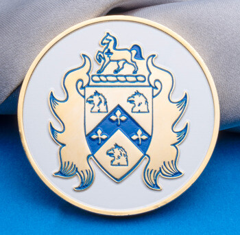 Circular challenge coin featuring a gold and blue heraldic shield and horse crest on a white enamel background.