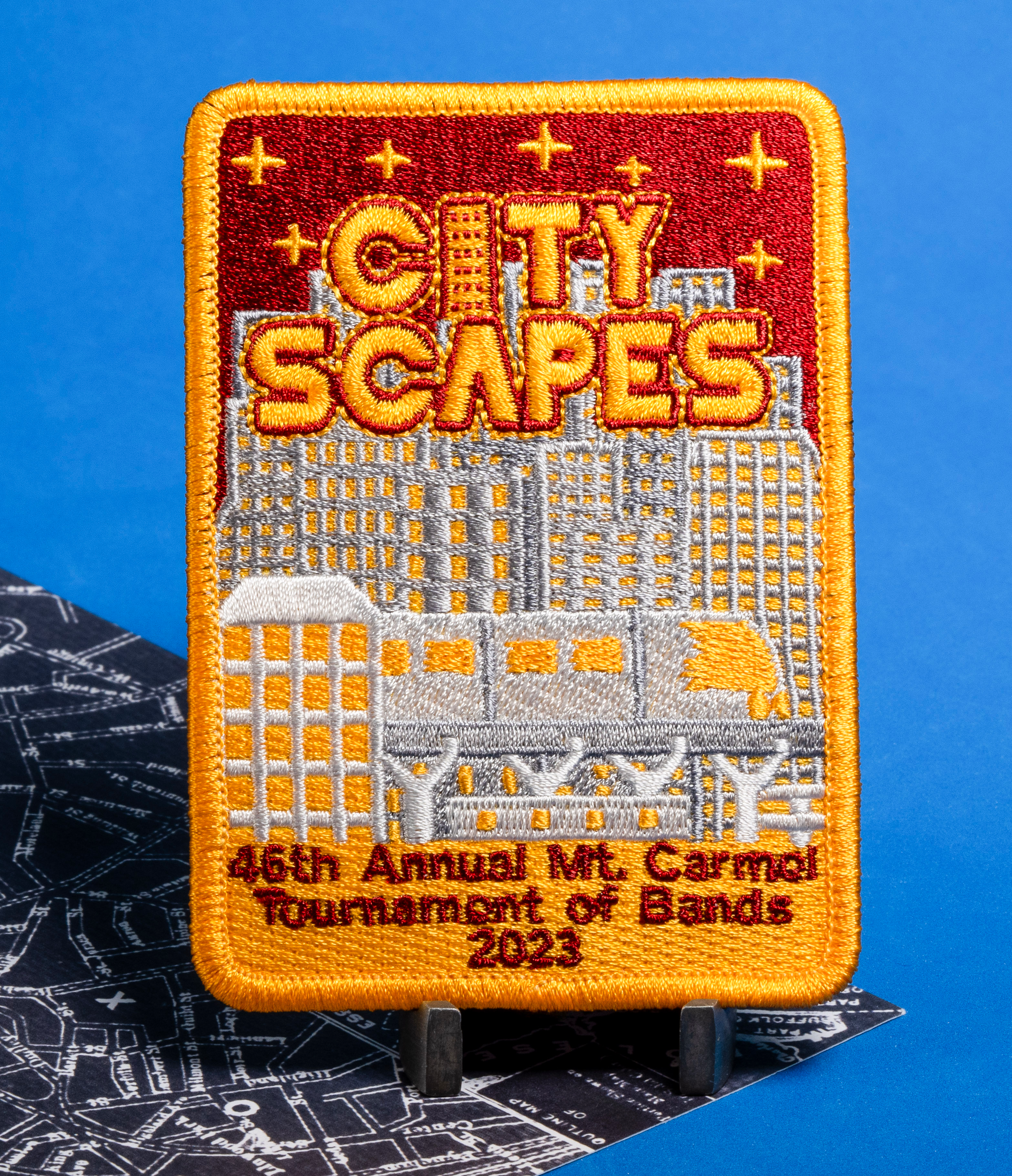 Rectangular embroidered patch featuring a skyline, 'City Scapes' text, and '46th Annual Mt. Carmel Tournament of Bands 2023'.