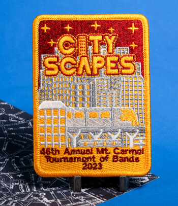Rectangular embroidered patch featuring a skyline, 'City Scapes' text, and '46th Annual Mt. Carmel Tournament of Bands 2023'.