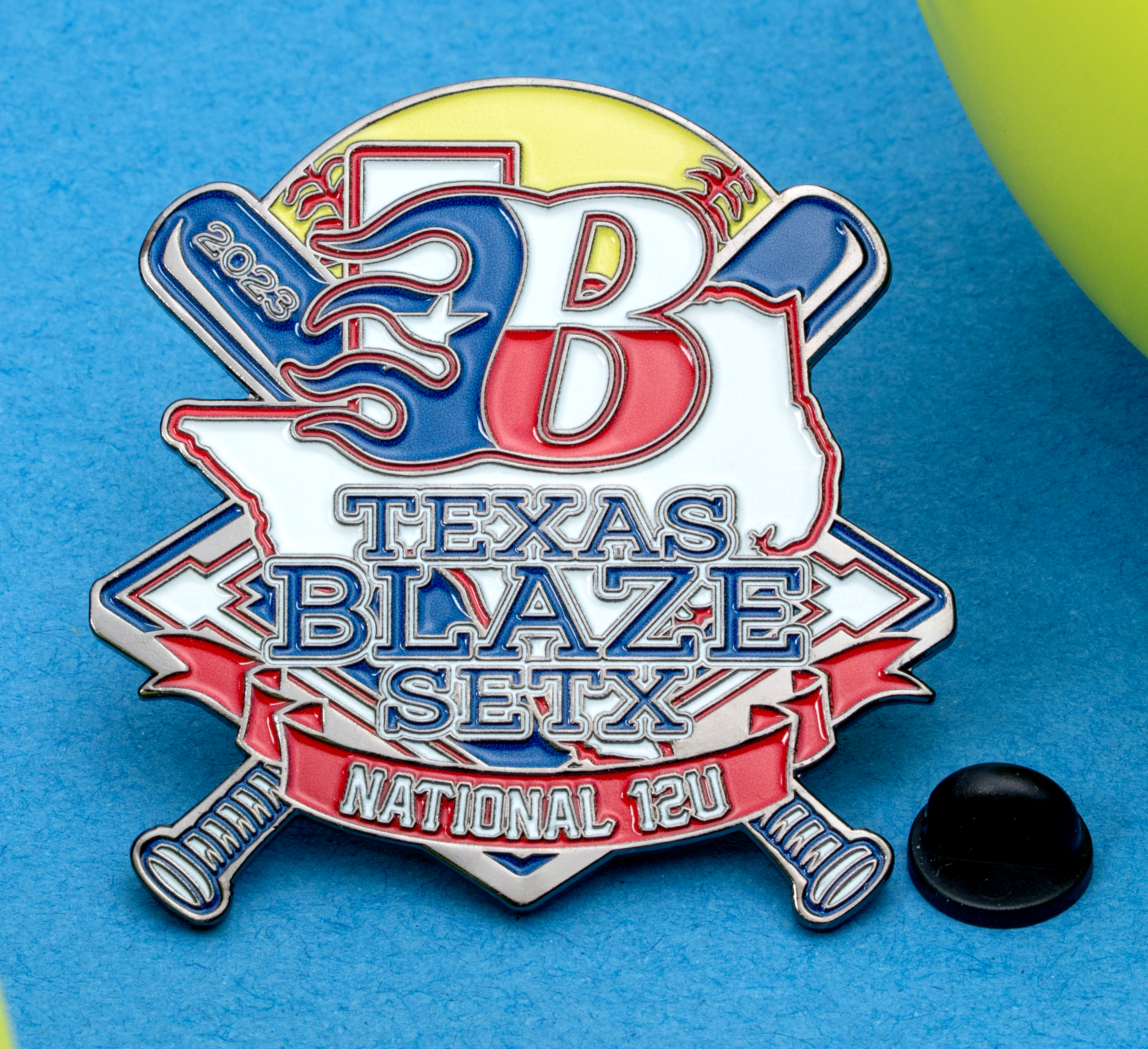 Enamel lapel pin for Texas Blaze SETX featuring a flaming B, state outline, and crossed bats with softballs.