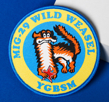 Circular embroidered MiG-29 Wild Weasel patch featuring a cartoon weasel and red star on a blue and yellow background.