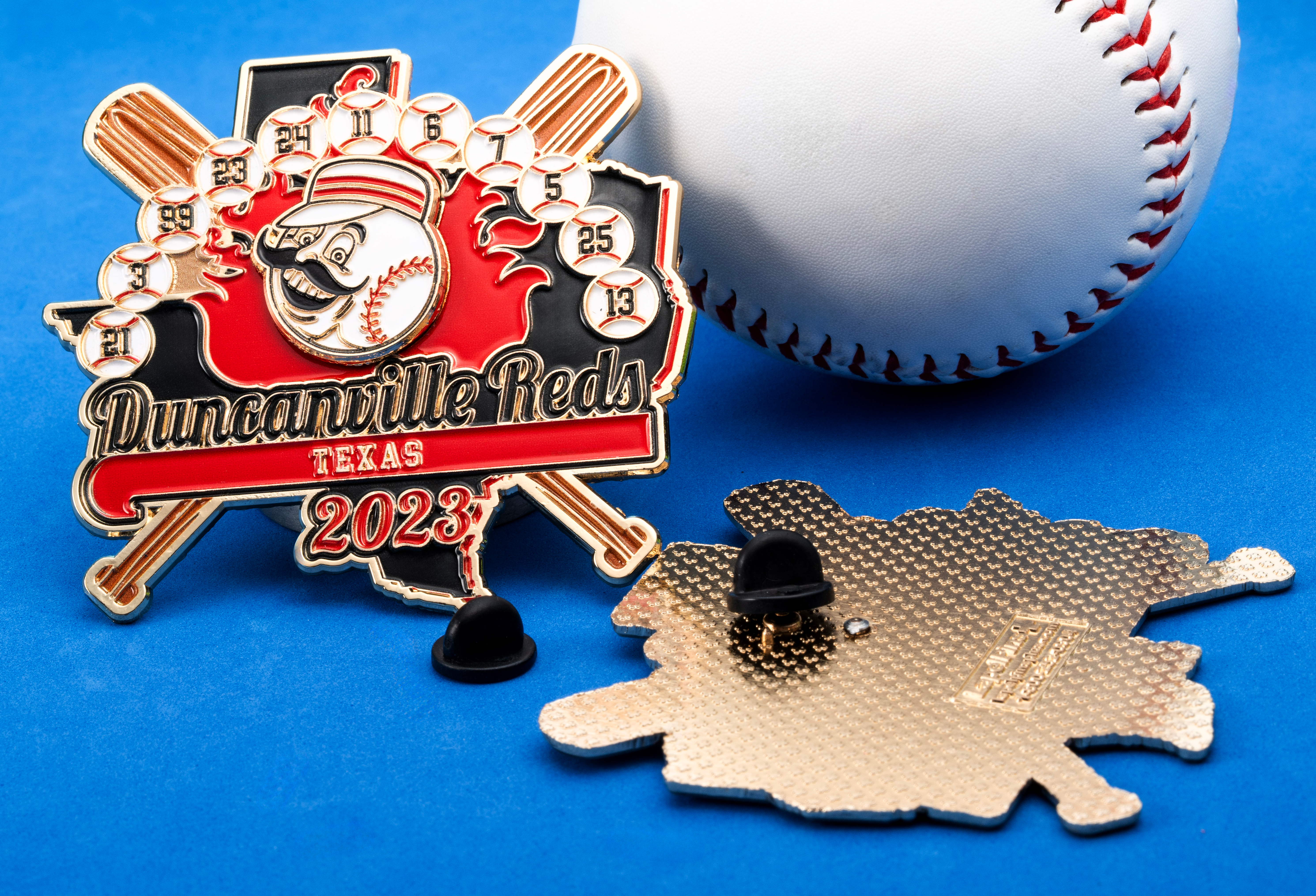 Custom baseball lapel pin featuring the Duncanville Reds logo, crossed bats, and small baseballs with numbers against a blue background next to a baseball.