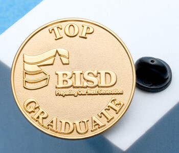 Gold round lapel pin with BISD logo and Top Graduate text, displayed on a white block with a black rubber clutch.