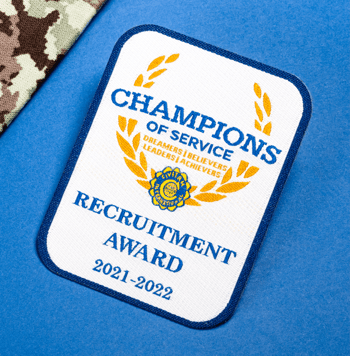 Rectangular embroidered patch with blue border reading Champions of Service Recruitment Award 2021-2022 featuring a gold laurel wreath and Civitan logo.