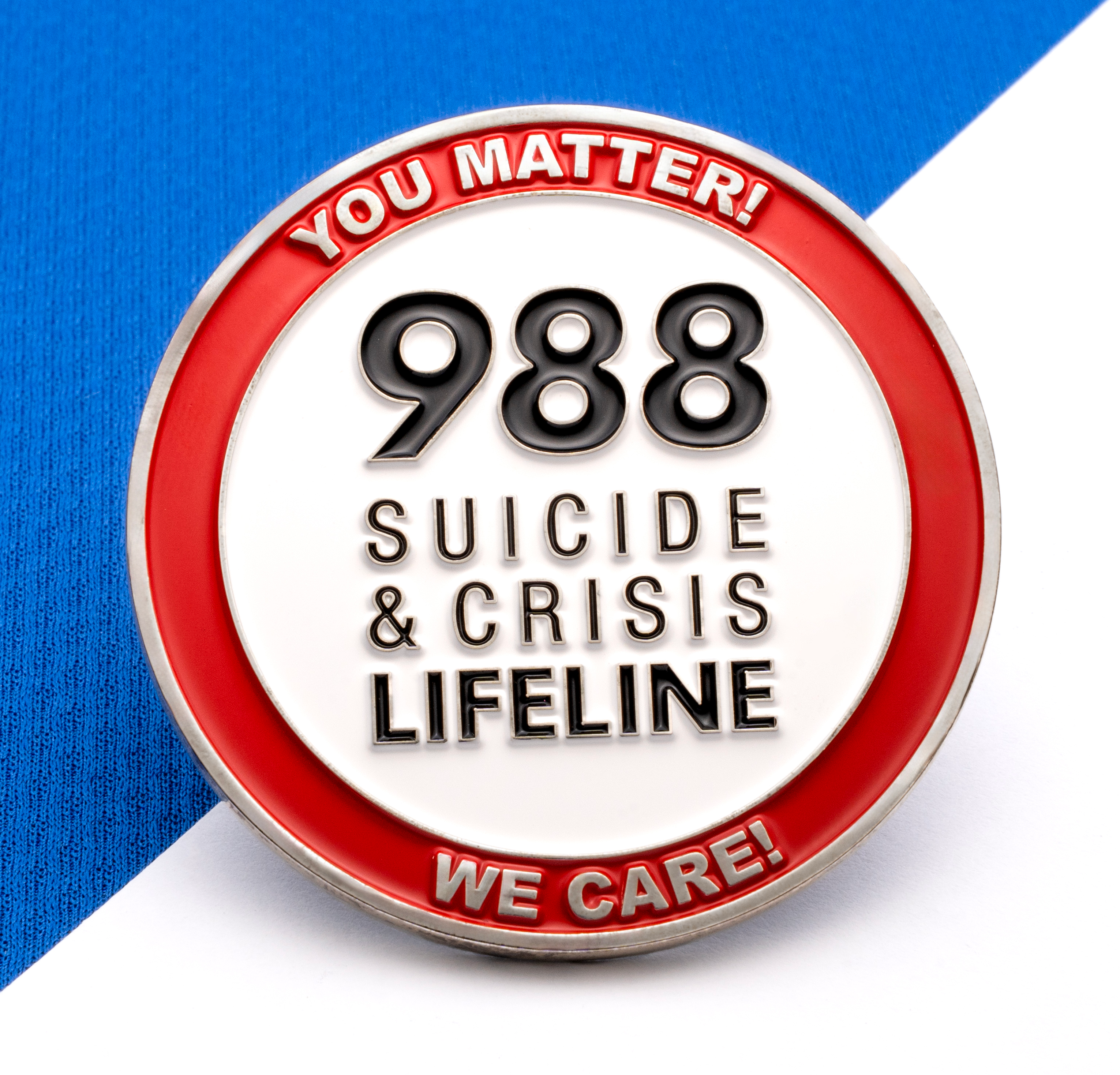 A circular enamel pin featuring the 988 Suicide & Crisis Lifeline logo with a red border containing the text You Matter! and We Care!.