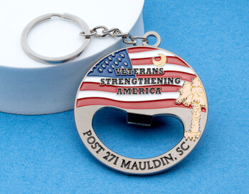 Circular metal keychain bottle opener featuring an American flag design, palm tree, and text reading Veterans Strengthening America Post 271 Mauldin, SC.