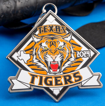 Diamond-shaped custom medal featuring a snarling tiger head, the state of Texas, and 'Texas Tigers 2024' text on a blue surface with a baseball bat.