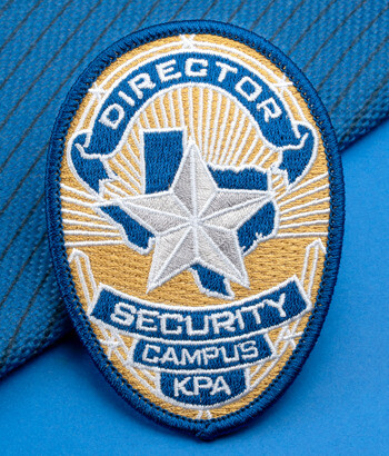 Embroidered shield-shaped security patch featuring a silver star over a Texas map silhouette with text Director Security Campus KPA.