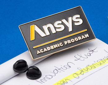 A rectangular black lapel pin with the Ansys logo and Academic Program text resting on a notepad next to a yellow highlighter.