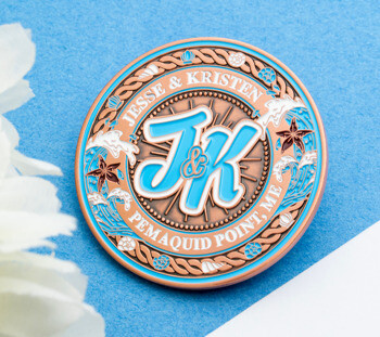 Custom challenge coin featuring light blue JK initials, waves, and seashells for Jesse & Kristen at Pemaquid Point.