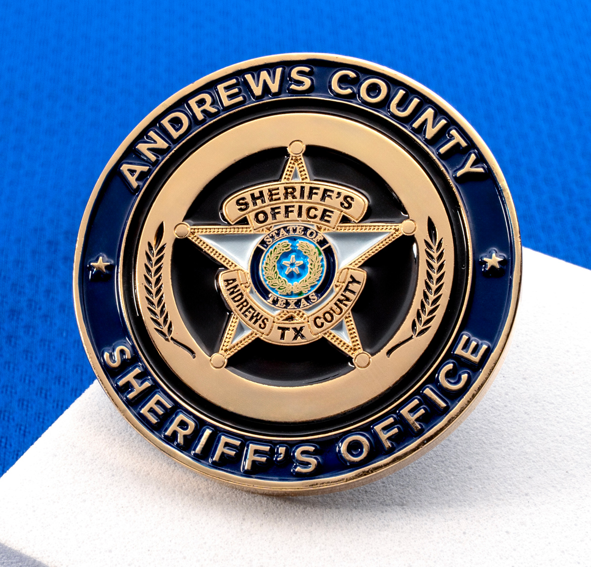 Circular Andrews County Sheriff's Office challenge coin with a gold five-point star and blue enamel background.