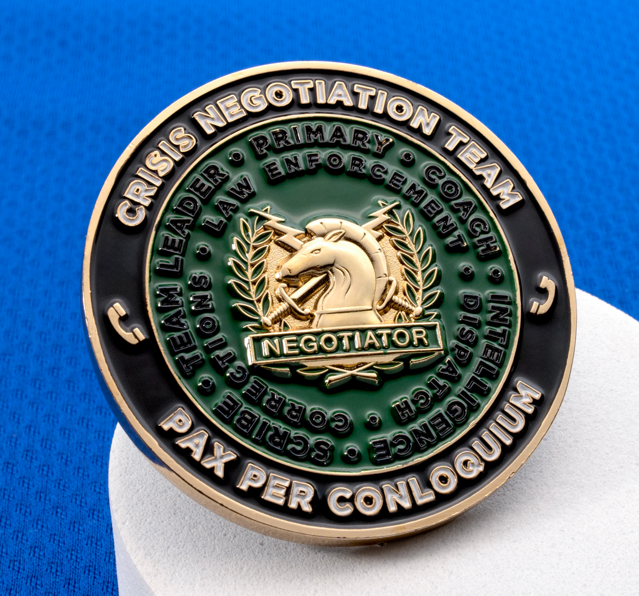 Crisis Negotiation Team challenge coin with gold knight chess piece emblem on a green and black background.