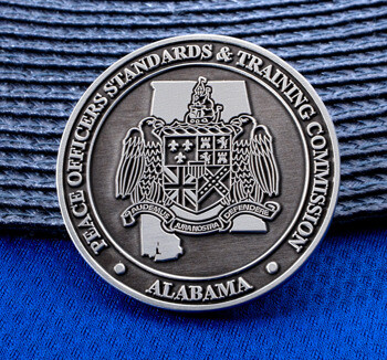 Antiqued silver challenge coin for the Alabama Peace Officers Standards & Training Commission featuring the state seal.