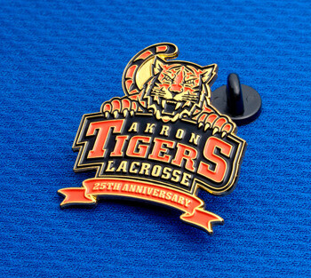 Akron Tigers Lacrosse 25th anniversary lapel pin featuring a tiger head and gold accents on a blue background.