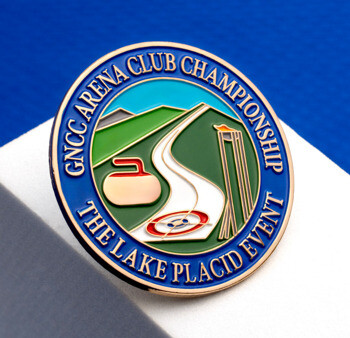 Circular lapel pin for the GNCC Arena Club Championship Lake Placid Event featuring a curling stone and target design.