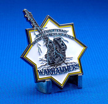 Star-shaped challenge coin for the 409th Expeditionary Security Forces Squadron Warhammers featuring a lightning-struck sword and tower.