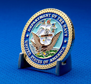 Department of the Navy challenge coin featuring an eagle, anchor, and sailing ship with a rope border on a blue background.