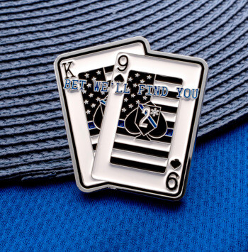 Enamel lapel pin shaped like two playing cards featuring thin blue line flags and K9 spade logos.