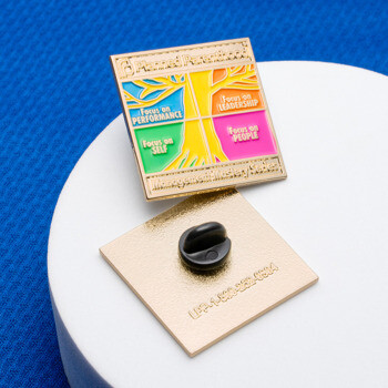 Square gold-plated lapel pin for Planned Parenthood featuring a colorful tree design with leadership and performance focus areas.