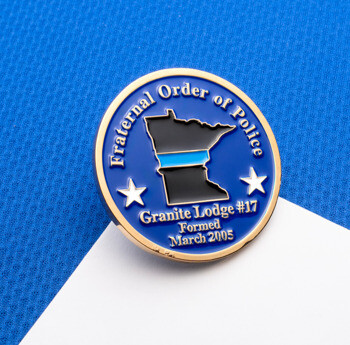 Circular lapel pin for Fraternal Order of Police Granite Lodge #17 featuring a Minnesota state outline with a thin blue line on a blue background.