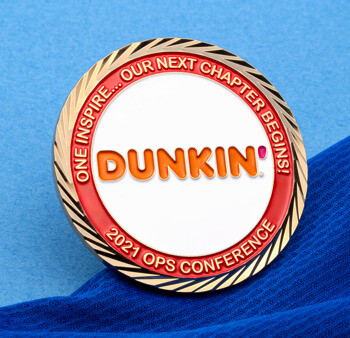 Round Dunkin' 2021 Ops Conference challenge coin with a gold diagonal-cut edge, white center, and red outer ring.
