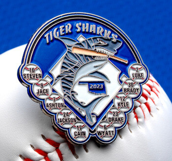 Tiger Sharks baseball trading lapel pin featuring a shark biting a bat, player names, and a 2023 date on a white baseball background.