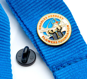 Enamel lapel pin with the Charles Herbert Flowers Foundation logo attached to a blue woven lanyard.