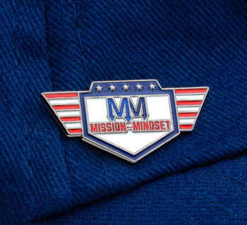 Mission Mindset lapel pin with red, white, and blue wings and stars design, pinned onto a blue fabric hat.