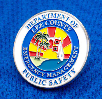 Lee County Department of Public Safety Emergency Management custom challenge coin with a tropical palm tree and sunset design on a blue textured background.