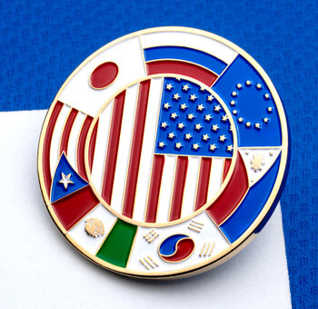 A circular challenge coin with gold plating, featuring a central US flag surrounded by international flag segments, including Japan and South Korea.
