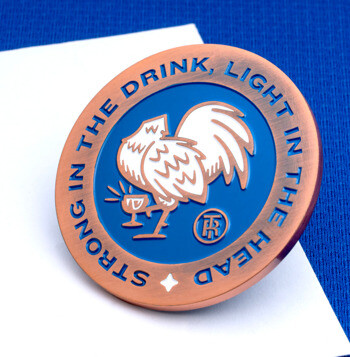 Circular copper challenge coin with blue enamel, a white rooster, and the text Strong in the Drink, Light in the Head.