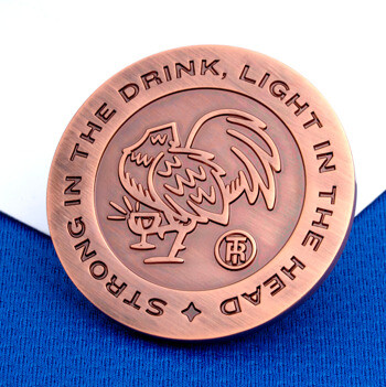 Antiqued copper challenge coin featuring a rooster illustration and the text Strong in the Drink, Light in the Head.