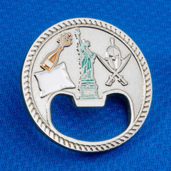 Circular silver challenge coin bottle opener featuring the Statue of Liberty, a champagne bottle, and a Spartan helmet.