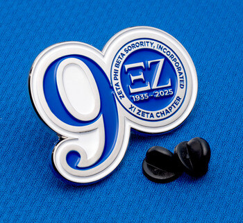 Zeta Phi Beta Sorority, Incorporated Xi Zeta Chapter enamel lapel pin shaped like the number 9 with black rubber clutches on blue fabric.