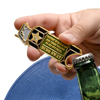 Custom gold and enamel BCSO SWAT bottle opener challenge coin featuring a star emblem and green text field being used on a glass bottle.